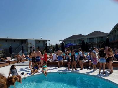 A group at the pool at an oceanfront hotel in the Hamptons.