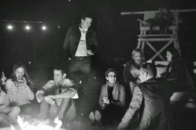 A group enjoying a bonfire on vacation in the Hamptons.