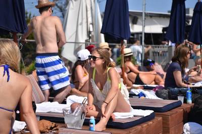 A girl soaks up the sun on her Hamptons vacation at our oceanfront hotel. 