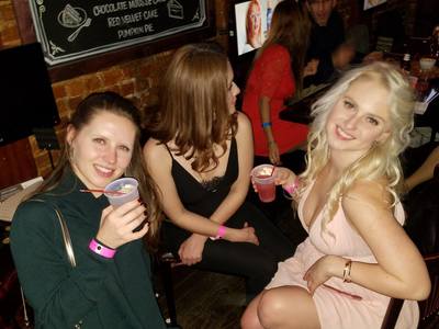 A group of girls from NYC drinking and having fun at a party. 