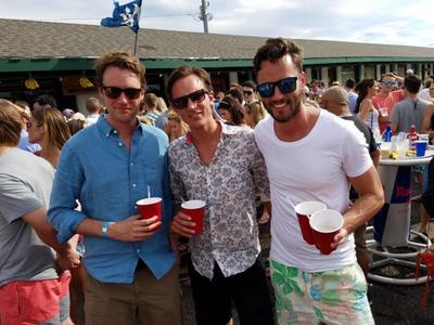 A group of guys drinking at a pool party in the Hamptons. 