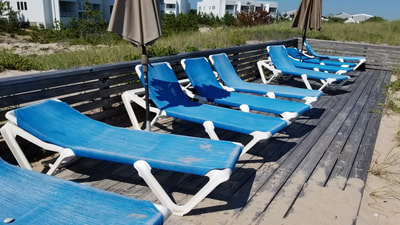 Lounge chairs on a private beach at an oceanfront hotel in the Hamptons. 