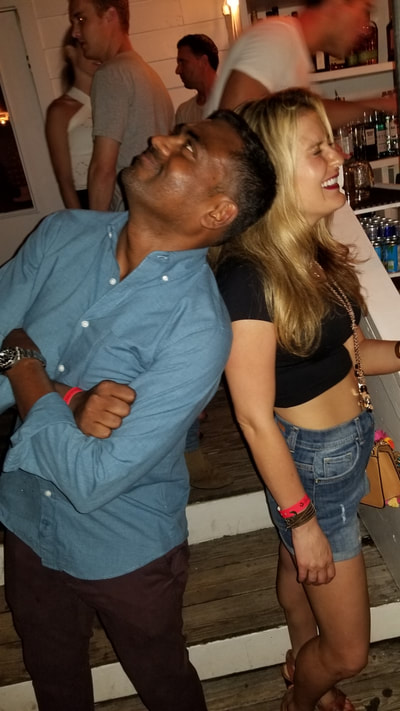 A guy and girl partying in the Hamptons. 