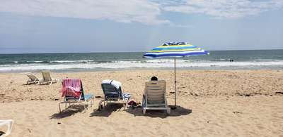 Three chairs lined up on our private beach in the Hamptons