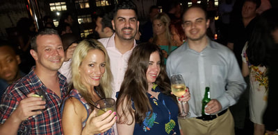 A group of friends with drinks at a party in NYC.
