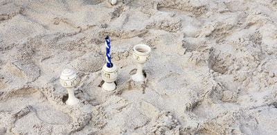 candles in the sand for shabbat