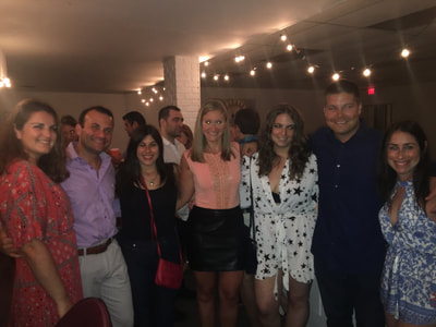 young professionals from NYC on a singles trip in the event space of our oceanfront hotel in  the hamptons