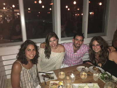 friends enjoy dinner at one of the best restaurants in montauk on their weekend trip for singles in the hamptons