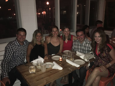 young professioanls from nyc enjoying dinner during their weekend get-away to montauk