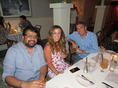 A group enjoying dinner while on a weekend vacation in the Hamptons. 