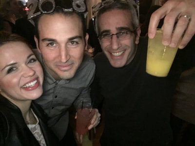 Friends take selfies with drinks at a trendy Manhattan party. 