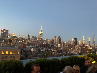 The Manhattan skyline at dusk taken from a rooftop party 